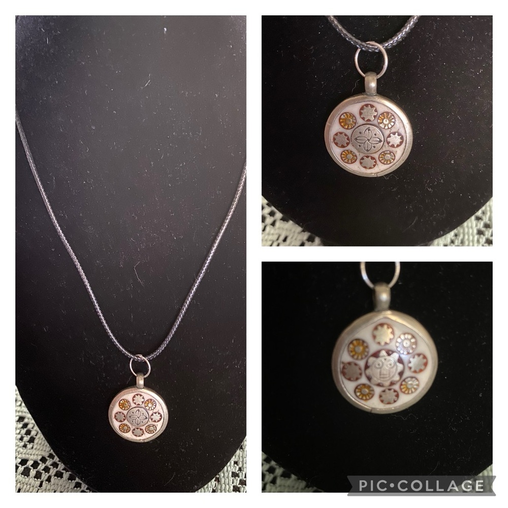 This is a small lot of 4 necklace on black cords with silver clasp.  beautiful